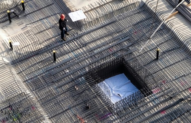 Ground beams and pile caps - Man at work in the basement